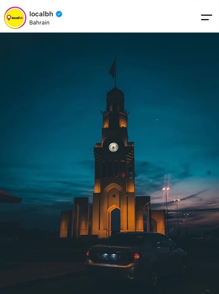 Bahrain Financial Harbour clock tower at dusk, reposted by localbh